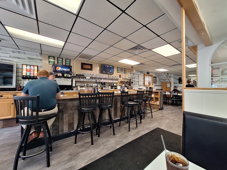 Bright breakfast tables inside a neighborhood diner.